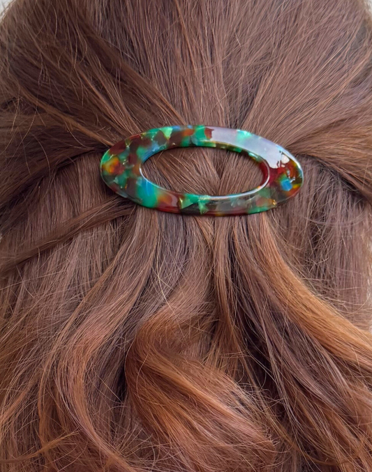 Multicolored hair clip on brown hair